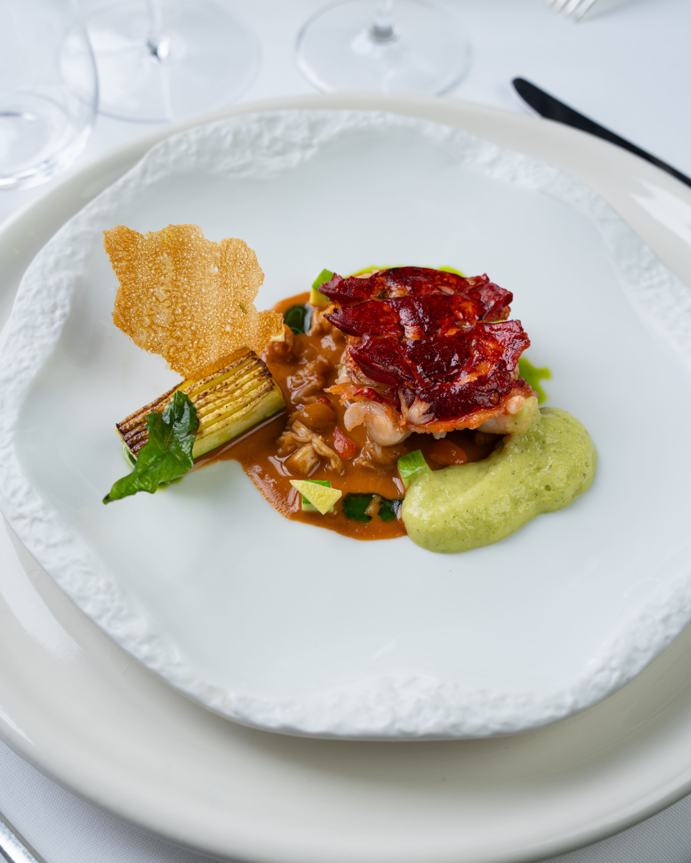 ‘Raw and cooked’ lobster on coral, violin courgette with verbena, lobster ‘leather’ €220